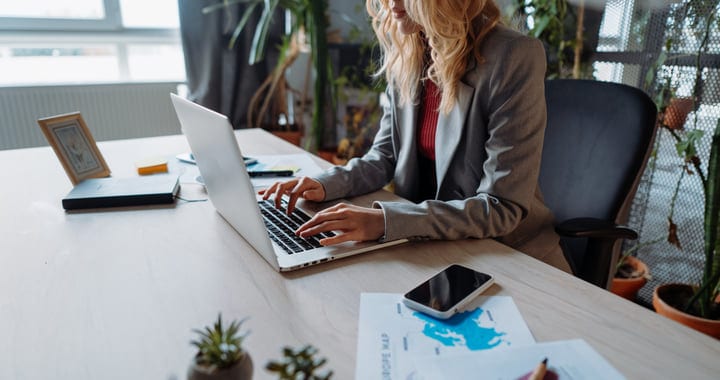 Focused Businesswoman Typing In A Modern Office Setting