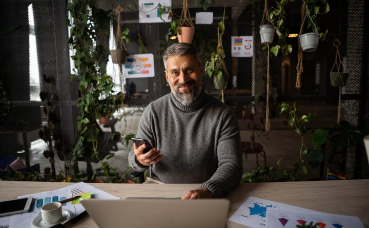A Businessman Embraces Nature in the Modern Office Space
