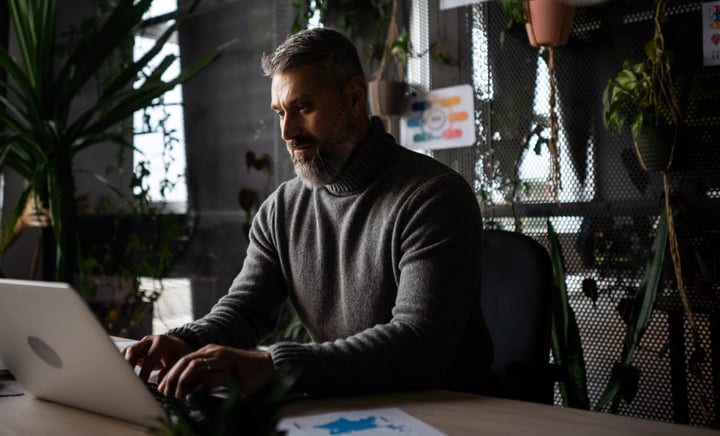 Focused Businessman Typing in a Stylish Office Setting