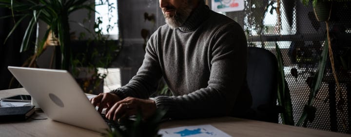 Focused Professional Typing in a Modern Office Environment