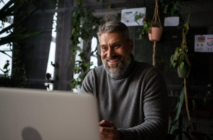 Smiling Professional Engages In A Lush Green Office