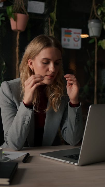 Focused Businesswoman Deep In Thought At Her Desk