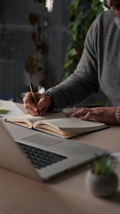 Focused Hands Pace Through Pages In a Sunlit Office