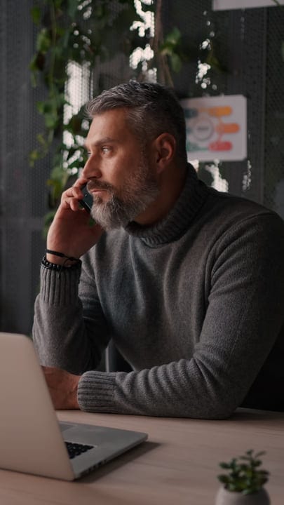 Mature Businessman Engaged In Thoughtful Phone Conversation