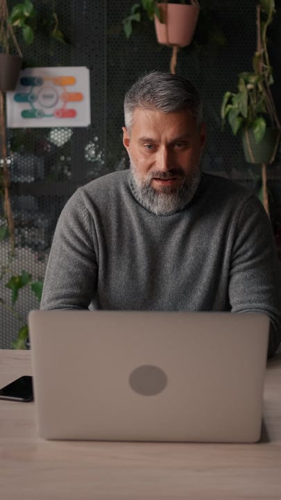 Focused Senior Professional Engages in Thoughtful Office Work