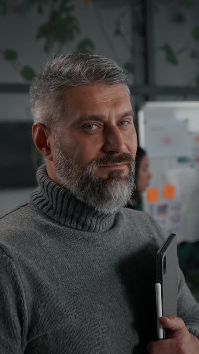 Contemplative Businessman Holding Tablet In Modern Office
