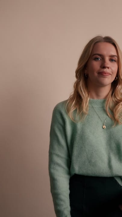 Professional Woman Smiling Confidently in Cozy Office Setting