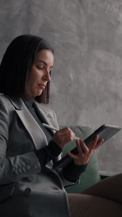 Focused Businesswoman Using Digital Tablet in Office Setting