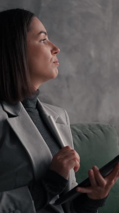 Contemplative Businesswoman Engages With Digital Tablet Indoors