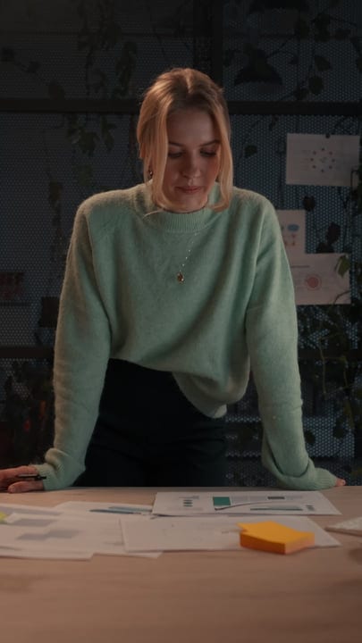 Focused Businesswoman Analyzing Reports in Cozy Office Setting