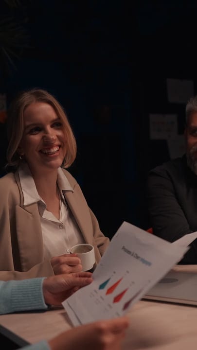 A Businesswoman's Smile Brightens A Late Night Meeting