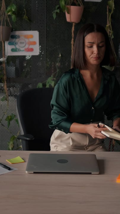 Focused Businesswoman Organizing Her Desk in Urban Office