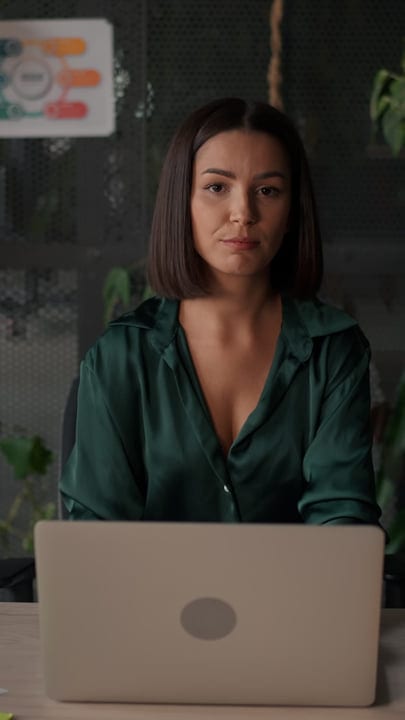 Focused Businesswoman Engages with Her Laptop in Modern Office
