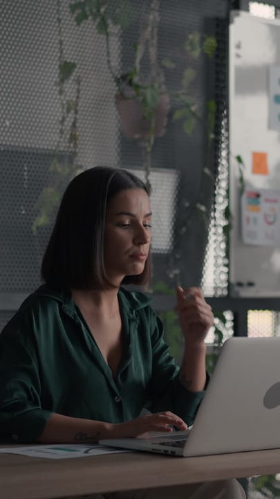 Focused Businesswoman Engages in Deep Thought at Her Desk