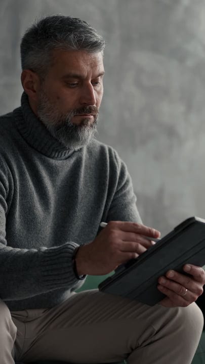 Thoughtful Professional Engaging with Technology in Office Space