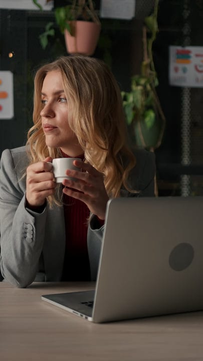 Businesswoman Reflects With Coffee In Her Cozy Office
