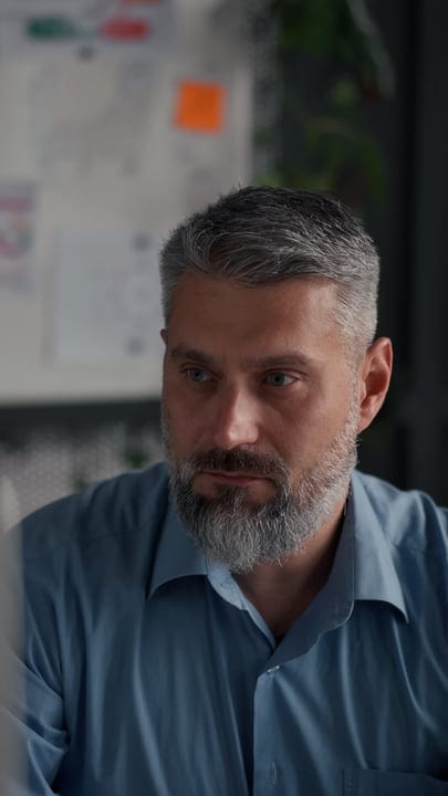Businessman Engaged in Thoughtful Work at Office Desk