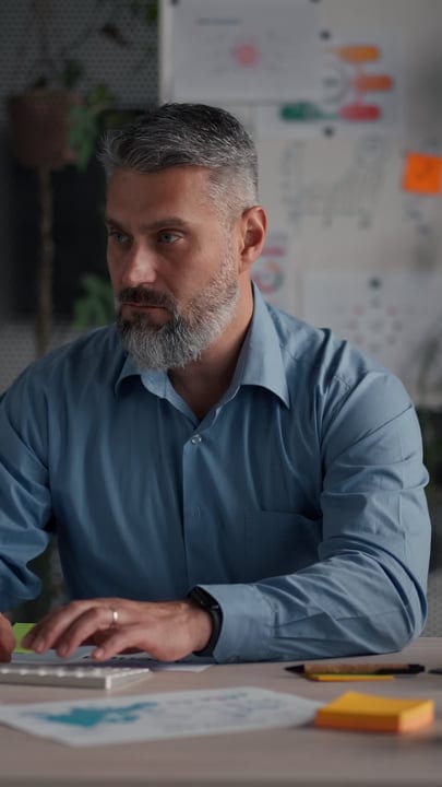 Focused Businessman Analyzing Data in Modern Office Space