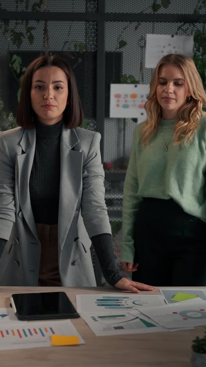 Confident Professionals Analyzing Reports in Modern Office