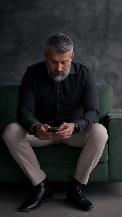 Focused Businessman Engaging With His Smartphone In Office