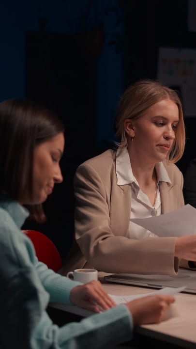 Focused Businesswomen Collaborating Late Into The Evening