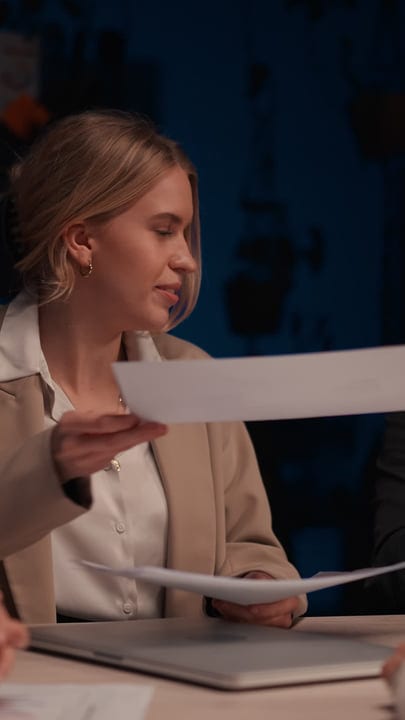 Focused Businesswoman Reviews Documents In Evening Office