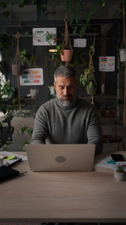 Focused Businessman Engages in Creative Office Space Work