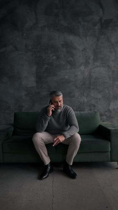 Reflective Businessman Engaged In Thoughtful Phone Conversation