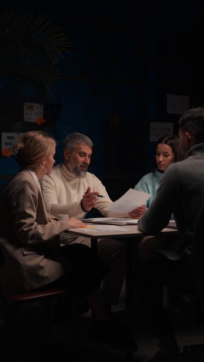 Collaborative Minds Spark Ideas In Dimly Lit Office