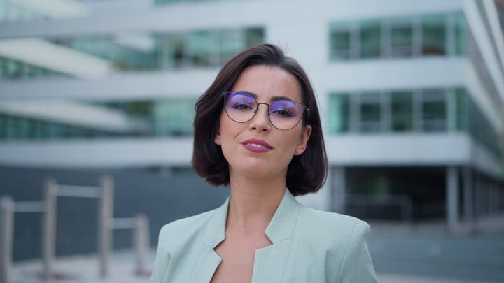 Confident Businesswoman Smiling Brightly In Urban Vienna Setting