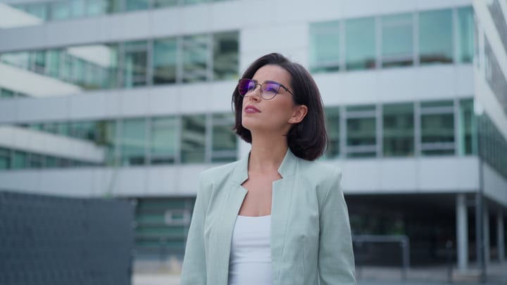 Contemplative Businesswoman Gazing At Modern Vienna Architecture