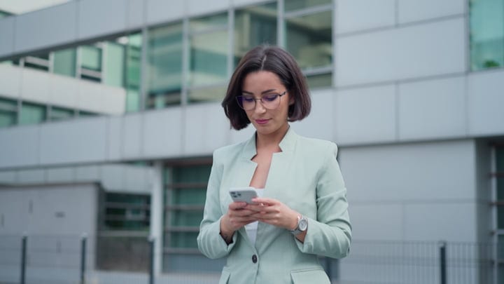 Confident Businesswoman Checks Her Phone in Urban Vienna