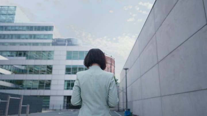 Confident Businesswoman Walks Through Modern Vienna Landscape