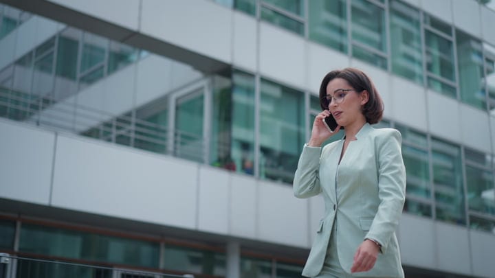 Confident Businesswoman Engaging in Phone Call Outdoors in Vienna