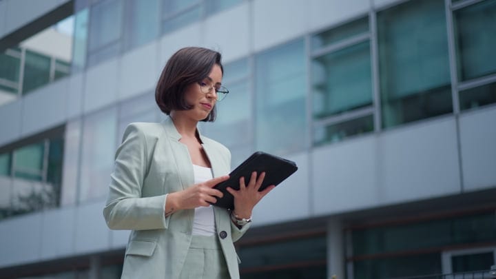 Confident Businesswoman Navigates Her Tablet In Vienna