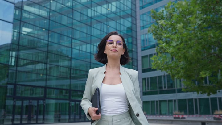 Confident Businesswoman Walking Through Vienna's Modern District