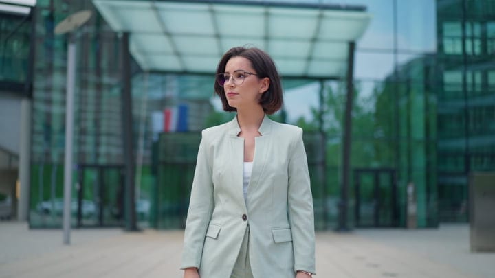Confident Businesswoman Strolls Through Modern Vienna Streets