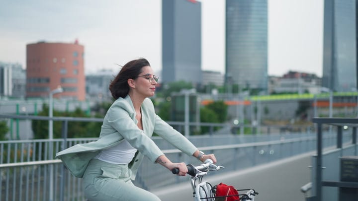 Confident Businesswoman Cycling Through Vienna's Urban Landscape