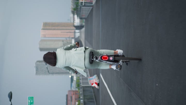 A Businesswoman Pedals Through Vienna’s Urban Landscape