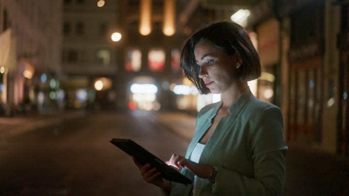 Businesswoman Engages With Technology In Vienna's Evening Glow