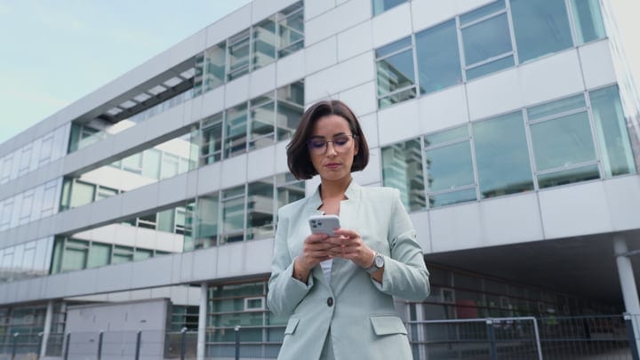 Focused Businesswoman Checking Messages In Vienna's Modern Hub
