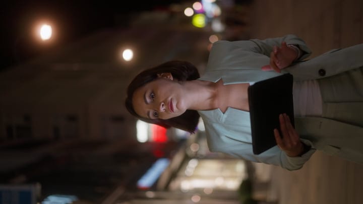 Businesswoman Engages With Tablet Under Vienna's Night Lights