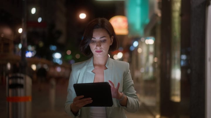 Focused Businesswoman Using Tablet In Vienna's Evening Glow