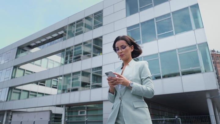 Modern Businesswoman Engages With Technology In Vienna's Urban Landscape