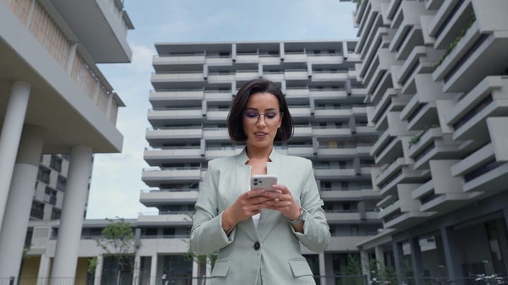 Confident Businesswoman Engages with Technology in Vienna's Modern Landscape