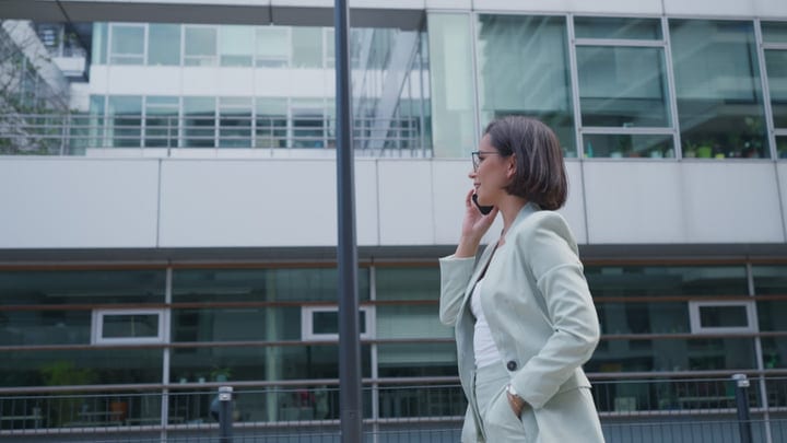 Confident Businesswoman Engages in Call Outside Vienna Office