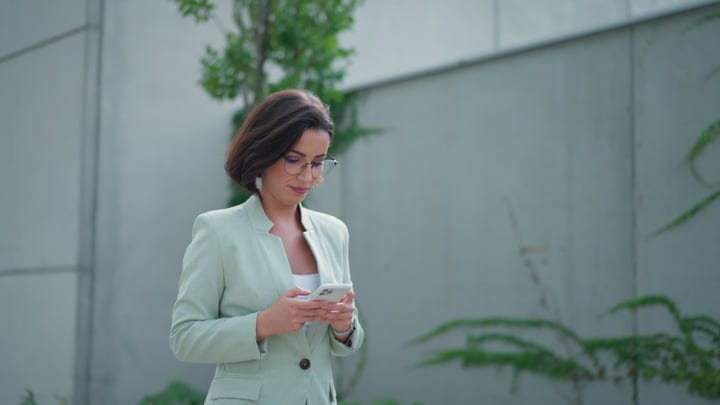 Confident Businesswoman Engaging With Her Phone In Vienna
