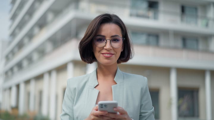 Confident Woman Engages With Technology In Urban Vienna Setting