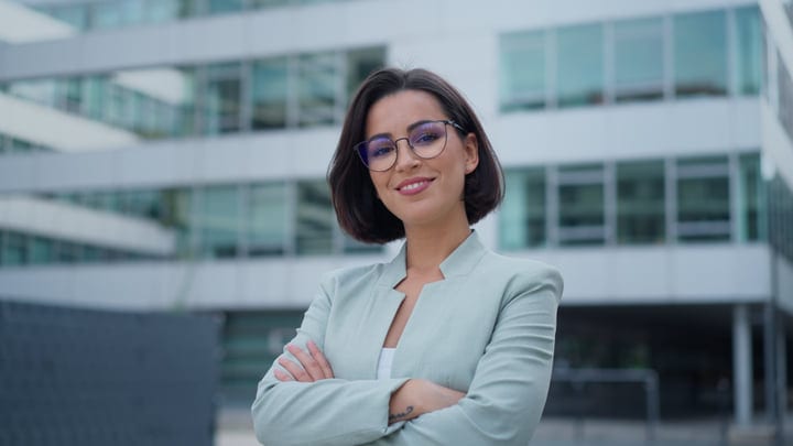 Confident Businesswoman Standing Outside Modern Office Building