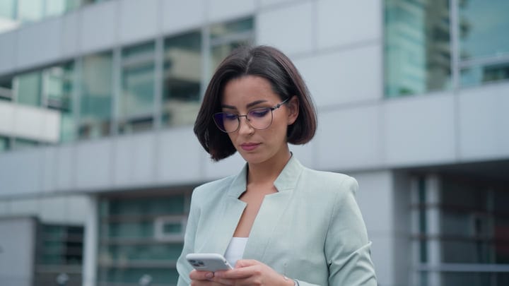 Modern Businesswoman In Vienna Focused On Her Smartphone